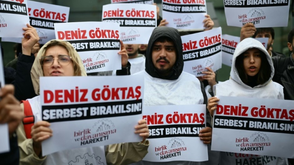 Protesters gathered outside court with placards reading: 'Release Deniz Goktas'