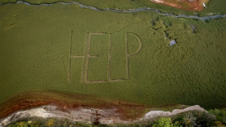 The word 'HELP' has appeared on the dry lake bed