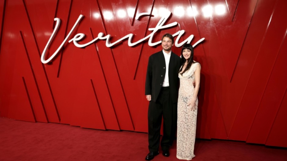 US actors Josh Hartnett and Dakota Johnson pose on the red carpet upon arrival to attend the UK Gala Screening of Verity, at the Curzon Mayfair, in London in September 2025