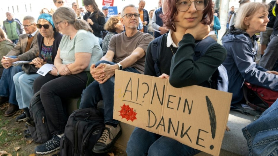 Protesters around the world -- seen here with a sign that reads 'AI? No thanks!' in Linz, Austria -- have voiced opposition to new data centers and their heavy demand on resources, as well as the use of AI in public surveillance and warfare