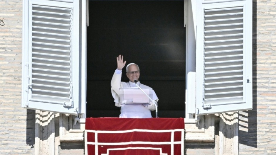 Pope Leo XIV waves during prayers in St Peter's Square on Sunday when he announced he would go into hospital