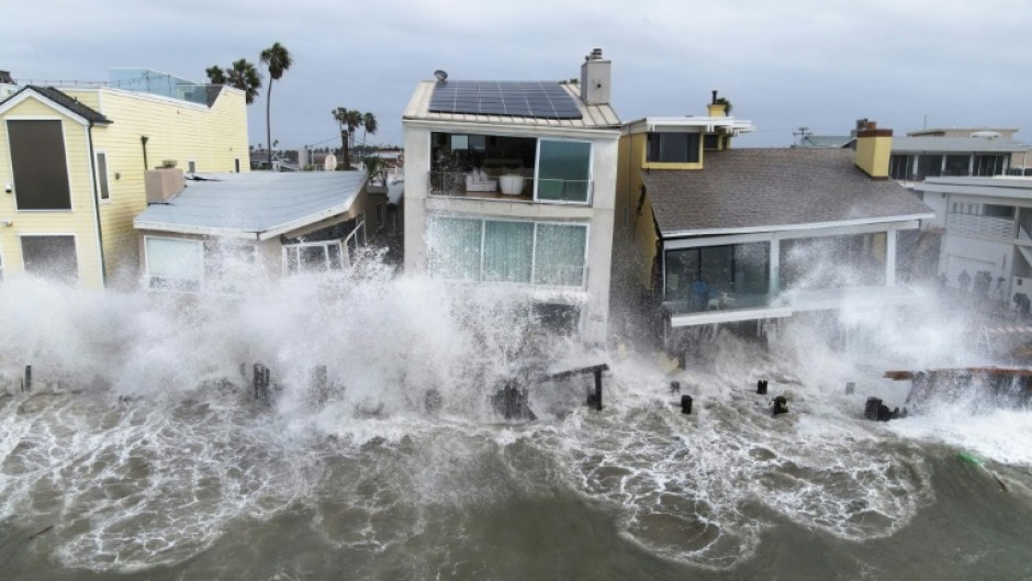 Storm waves created due to Tropical Storm Rachel crash into the boardwalk and homes in Long Beach, California, on October 11, 2026
