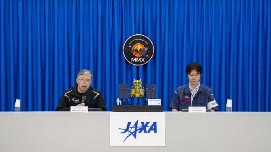 Yasuhiro Kawakatsu (L), project manager of the Mars Moons eXploration (MMX) mission, attends a press conference at the Tanegashima Space Center in Minamitane, Kagoshima prefecture on August 13, 2026