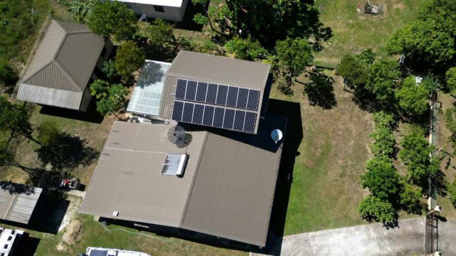This photo taken on October 9, 2026 shows an aerial view of a house fitted with solar panels in Rukurukulevu village on the coast of Fiji's Nadroga-Navosa province. As fuel prices rise, some in the village are turning to solar to move away from dependence on the national grid.