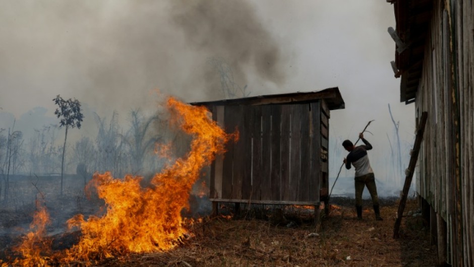 A man tries to contain a forest fire in Amazonas, Brazil