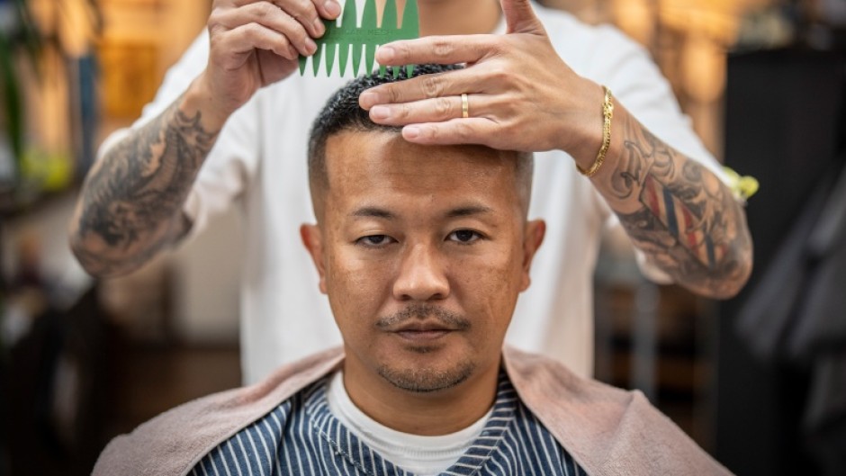 Barbers play a key role in helping Japan's mobsters project an image of mence and wealth