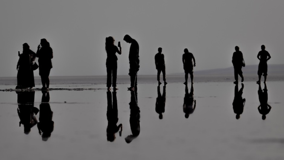 Tourists can walk along the surface of Tuz Golu salt lake in Turkey as water levels have hit a crisis low