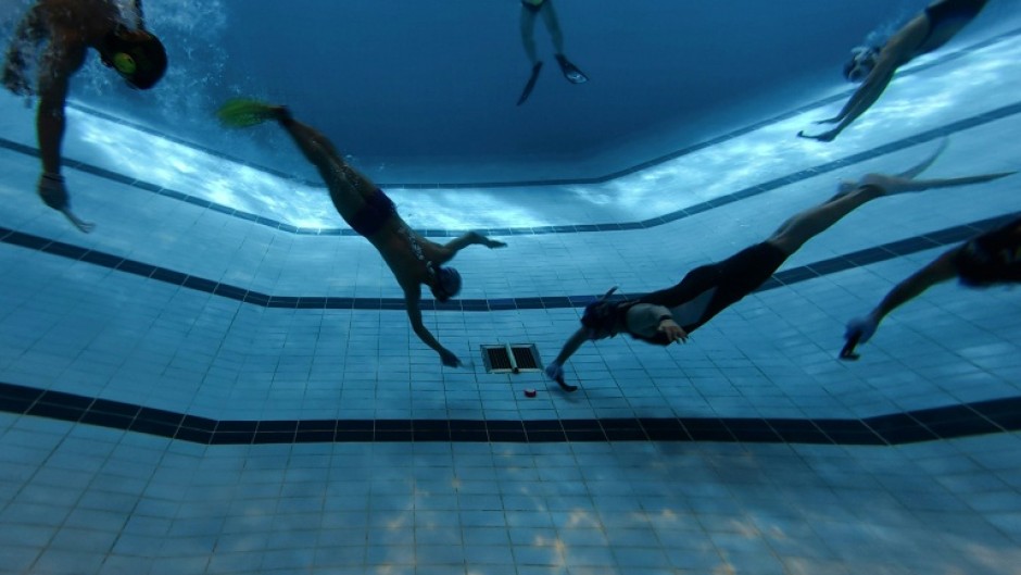 Underwater hockey players take part in the 2026 HKUWHA Under Water Hockey tournament in Hong Kong on October 17, 2026. The annual underwater hockey tournament, ominously advertised as "physical hell", nevertheless drew a roster of hardcore enthusiasts from countries across Asia.