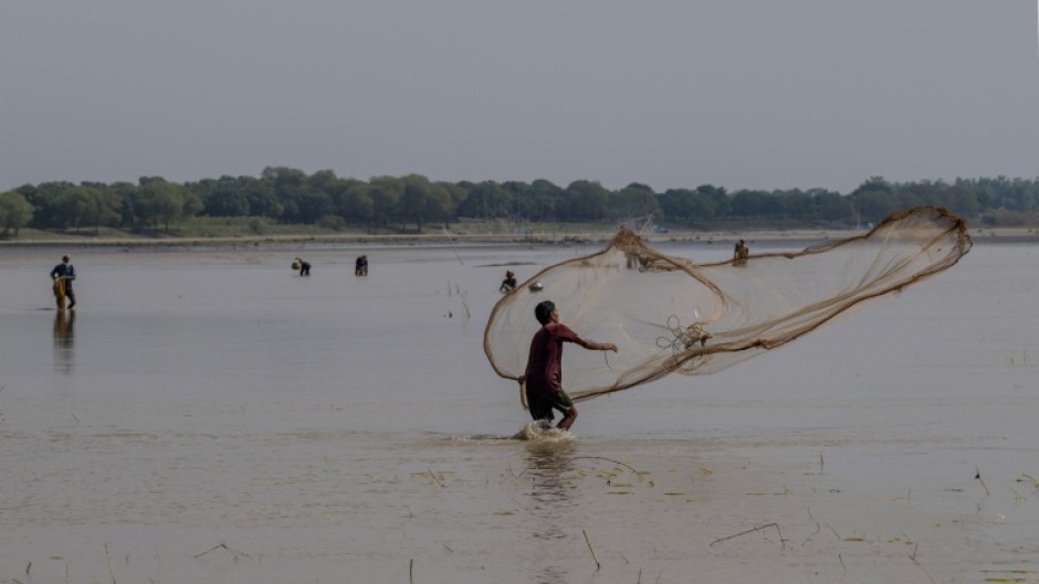 Aa fisherman casts his net along the Padma river at Ramnathpur village, near the Bangladesh-India frontier