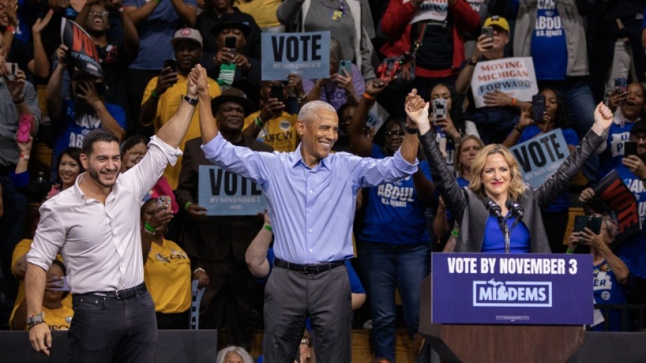 Former US president Barack Obama campaigns alongside Democrat Michigan senatorial candidate Abdul El-Sayed (L) and Michigan Secretary of State and Democrat gubernatorial candidate Jocelyn Benson (R)