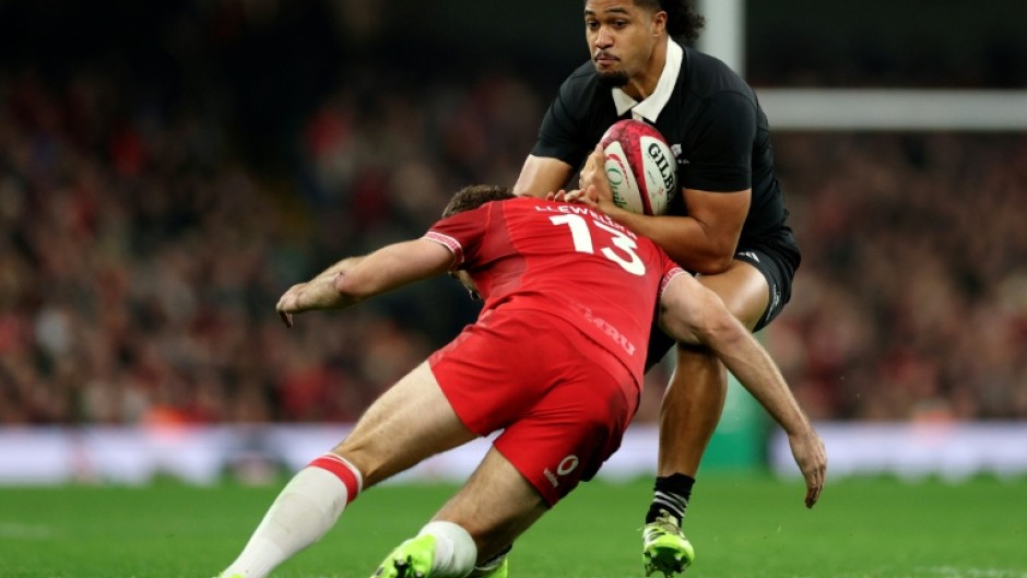 New Zealand's Leicester Fainga'anuku runs with the ball during the Autumn Nations Series International rugby union test match between Wales and New Zealand at the Principality Stadium, in Cardiff on November 22, 2025