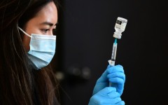 A Covid-19 vaccine is prepared for administration in the US, where a new study has helped provide some answers about the brain fog associated with the virus