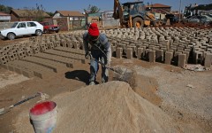 An informal brick maker works on the side of the road at the Mamelodi township.