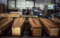 File: At a factory belonging to Europe's largest coffin maker, OGF, workers are doing overtime to meet demand from families parting with their loved ones.
