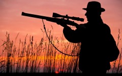 File: A hunter aims his rifle as the sun sets behind him. AFP/Patrick Pleul