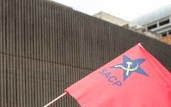 File: A flag displaying a logo of the South African Communist Party.
