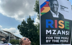 A RISE Mzansi member hanging a poster. Facebook/RISE Mzansi