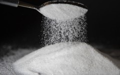 File: A person dumps sugar onto a table with a spoon. AFP/Thibaut Durand/Hans Lucas