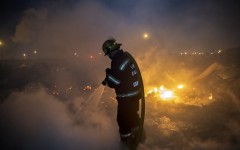 File: Members of the City of Cape Town Fire and Rescue Services extinguish a fire. AFP