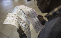 File: An early voter, checks his ballot papers at the Yeoville Recreation Centre in Johannesburg on May 27, 2024. 