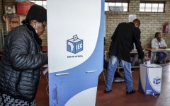 A voter marks her ballot papers in a voting booth. AFP/Phill Magakoe