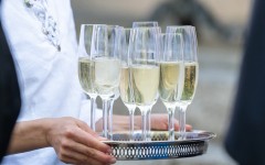 File: Glasses of sparkling wine are served on a tray. Silas Stein/dpa Picture-Alliance via AFP