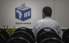 A man watches live voting results at the Independent Electoral Commission (IEC) National Results Center in Midrand on May 31, 2024. 