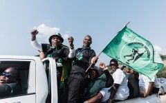 Supporters of the MK Party hold flags and chant slogans while celebrating. AFP/Rajesh Jantilal