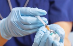 File: A healthcare worker fills a syringe with a vaccine. GettyImages/Andril Zorii