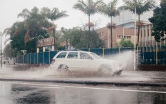 A vehicle drives through a flooded street following heavy rains. AFP/Rajesh Jantilal