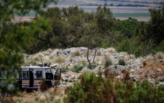 A SAPS vehicle near an opening to the mine shaft in Stilfontein. AFP/Phill Magakoe