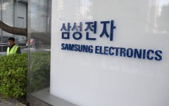 A man walks past the logo of Samsung Electronics displayed outside the company's Seocho building in Seoul. AFP/Jung Yeon-je