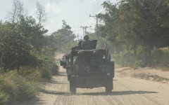 File: A military convoy of South Africa National Defence Forces (SANDF) rides along a dirt road. AFP/Alfredo Zuniga