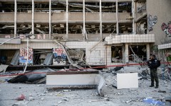 An Israeli police officer inspects the site where an Iranian ballistic missile reportedly struck in Haifa, Israel. Matan Golan/Middle East Images via AFP