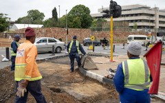 Road maintenance workers gather in a street under renovation in Braamfontein, Johannesburg, on November 7, 2025.