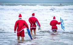Surfers dressed as Santa Claus. AFP/Giorgio Viera