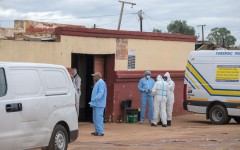 Forensic Pathology Services members stand at the scene of an attack at a tavern in Bekkersdal. AFP/Emmanuel Croset