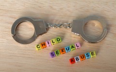 The words 'Child Sexual Abuse' with handcuffs. GettyImages/Abu Hanifah