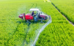 File: A farmer operating a vehicle to spray pesticides. Zhai Huiyong/Xinhua via AFP