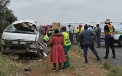 A rescue worker (2nd L) comforts a woman (L) at the scene of the Vaal accident. AFP/John Mkhize