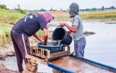 Residents wash soil in search of alleged gold deposits on makeshift tables at Gugulethu Informal Settlement in Springs. Gallo Images/OJ Koloti