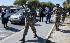 South African National Defence Force (SANDF) soldiers walk with South African Police Service (SAPS) officers in Mfuleni township in Cape Town on March 31, 2026.