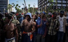 Protestors hold branches and sticks during a protest march against undocumented migrants organised by “March and March” in Johannesburg on April 29, 2026.