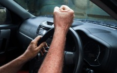 File: An angry car driver pulls a fist at another motorist. GettyImages/brazzo