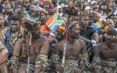 A South African flag is seen in a protester's head gear as he gathers with other protesters during a protest march against undocumented migrants in Durban on May 6, 2026.