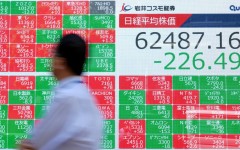 A man walks past an electronic quotation board displaying the Nikkei 225 stock prices on the Tokyo Stock Exchange. AFP/Kazuhiro Nogi