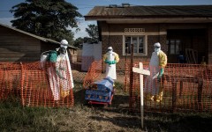 File: Medical workers disinfect the coffin of a deceased unconfirmed Ebola patient inside an Ebola Treatment Centre. AFP/John Wessels