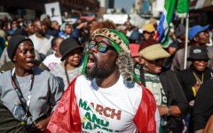 Protesters chant slogans as they march during a demonstration by the "March and March" and Operation Dudula movements. AFP/Phill Magakoe