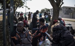 Malawian undocumented migrants sit in a shaded area in Durban. AFP/Marco Longari