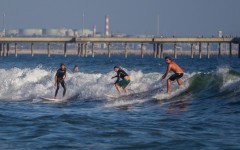 Surfers catch a wave at Venice Beach in Los Angeles, California. AFP/Apu Gomes